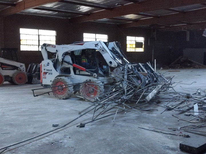 bobcat removing demolition debris - close up view