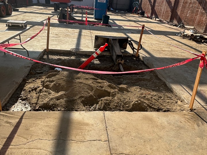 removing concrete slab section at demolition site