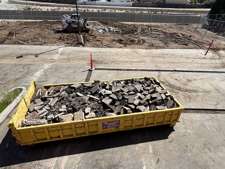 parking lot demoliton alongside dumpster