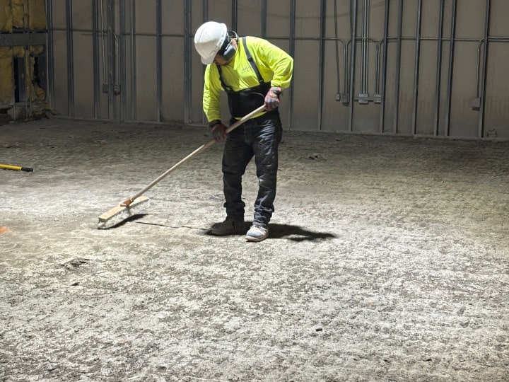 sweeping up floor during selection demolition phase