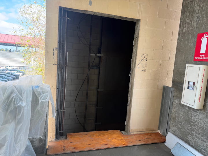 Elevator shaft opening framed by concrete block walls undergoing wall sawing modifications at Burbank Airport
