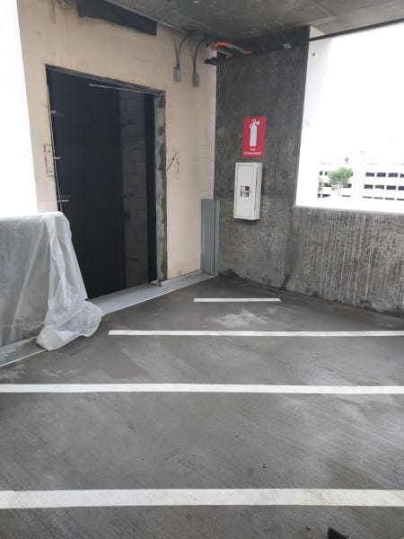 Elevator shaft opening framed by concrete block walls undergoing wall sawing modifications at Burbank Airport