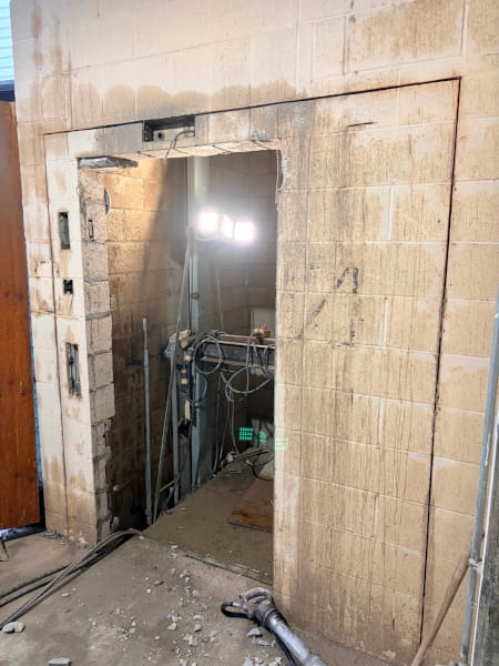 Outline of cut lines marked on a concrete elevator shaft wall prior to wall sawing